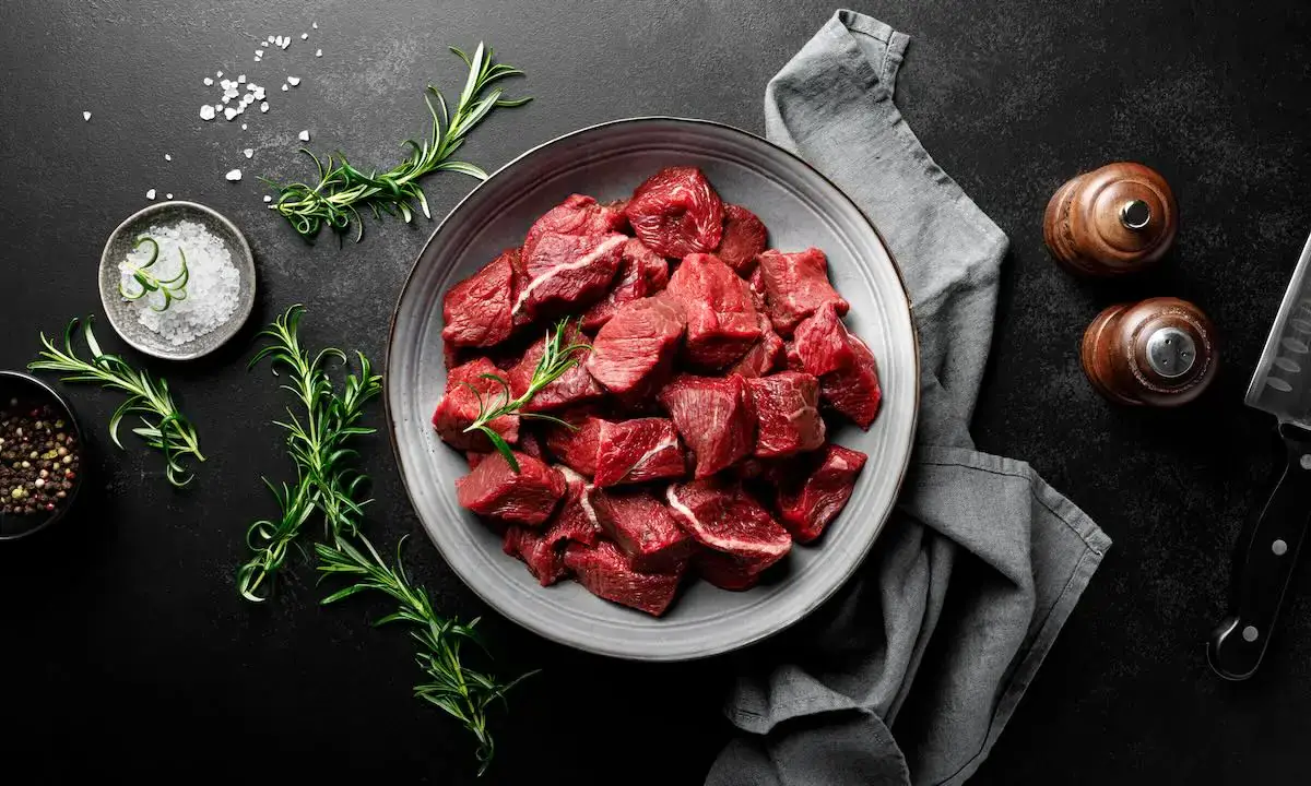 Cubed raw red meat in bowl, illustrating lean meat