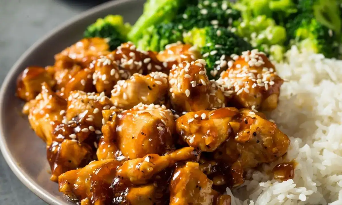 Teriyaki-glazed chicken with sesame seeds, white rice and steamed broccoli