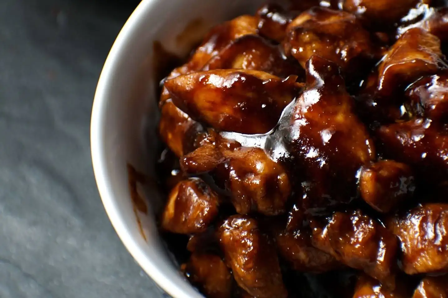 White bowl with glossy dark-brown glazed bite-sized pieces