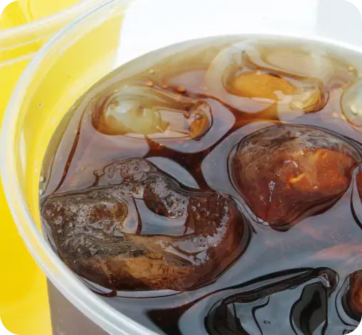 Sakura of Japan combo drinks: iced cola with ice and yellow beverage.