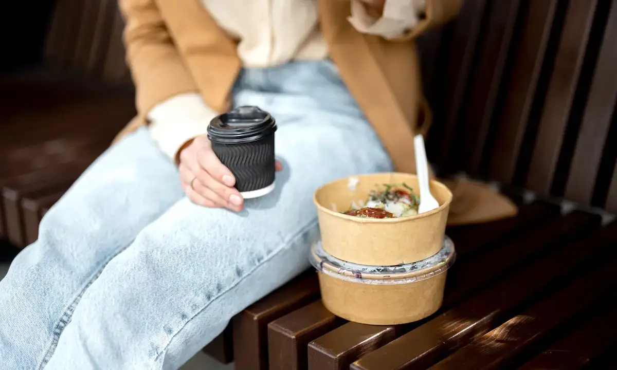 Sakura of Japan teriyaki takeout bowl and coffee on bench for office lunch delivery