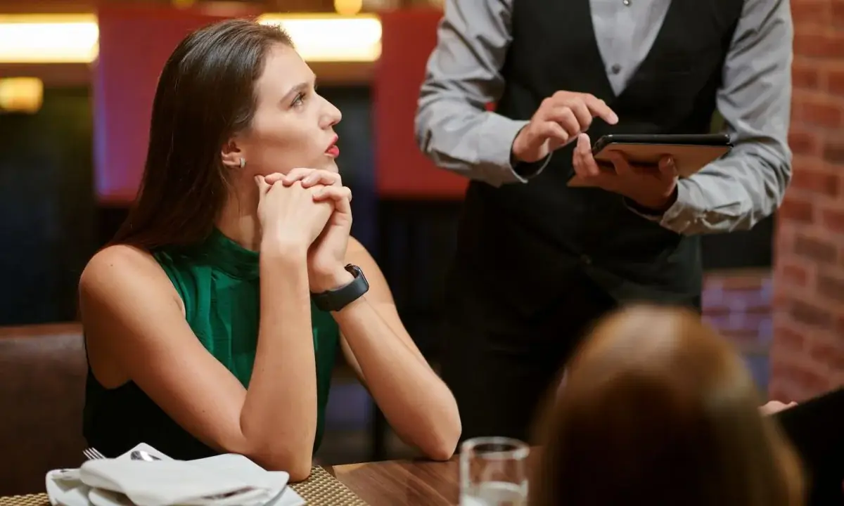 Woman asking waiter if teriyaki glaze is gluten-free